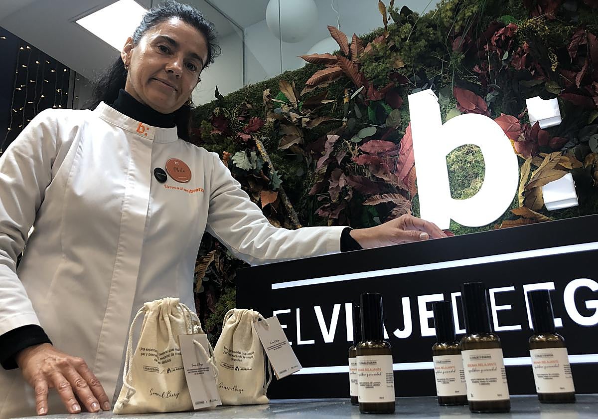 La titular de la Farmacia El Bierzo de Ponferrada, Marta Rodríguez Tato, junto a algunas de las muestras de bruma relajante de Las Médulas.