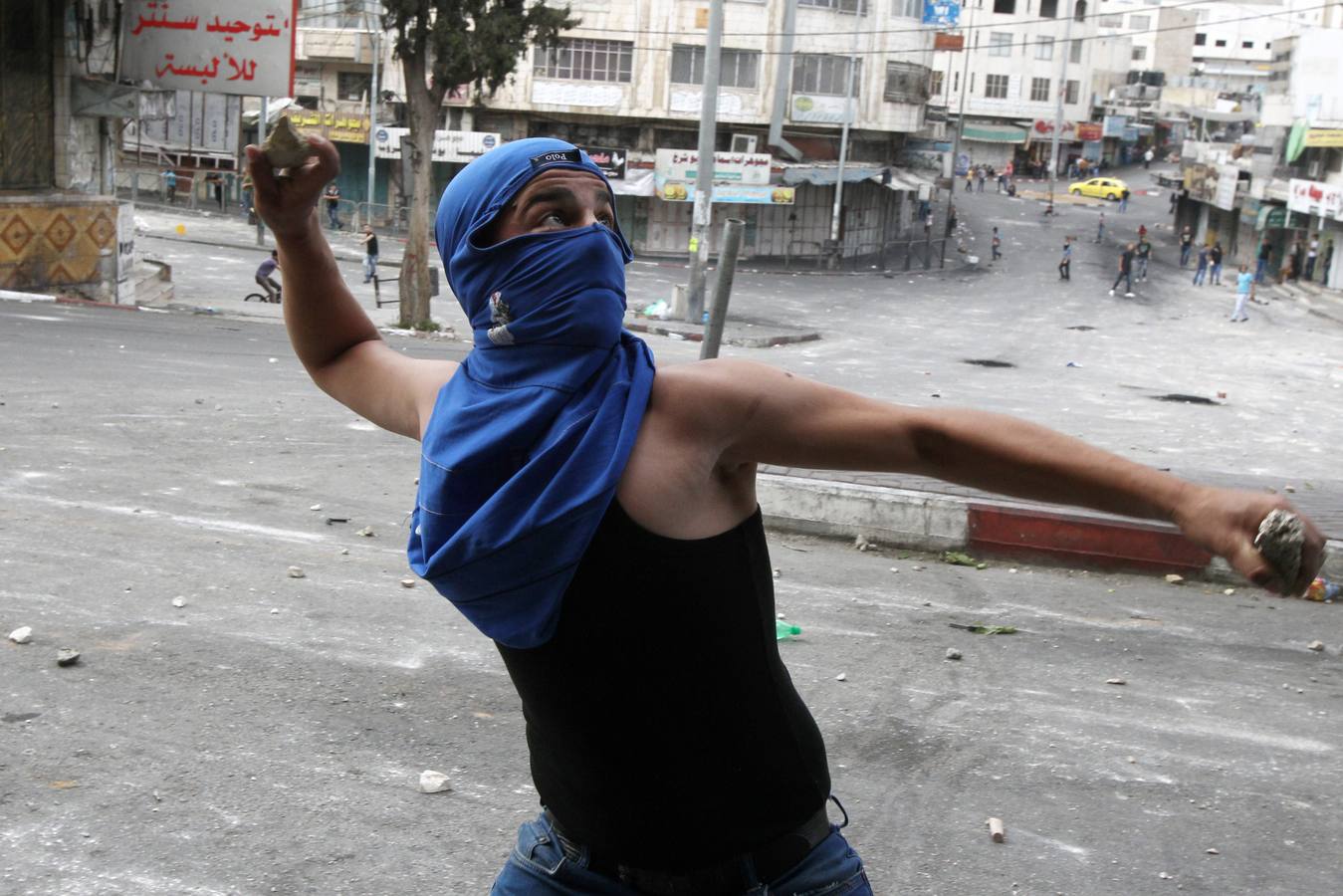 Lucha en Gaza. Un joven palestino lanza una piedra contra el ejército de Israel.