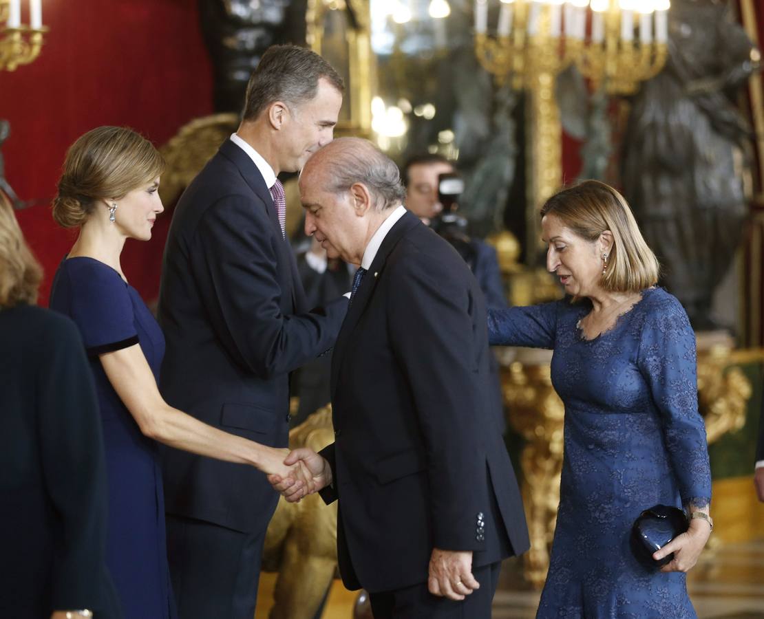 Doña Letizia saluda al ministro del Interior, Jorge Fernández Díaz, mientras el Rey saluda a la ministra de Fomento, Fátima Báñez.