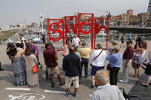 Varios cruceristas se fotografían ante las 'letronas'. 