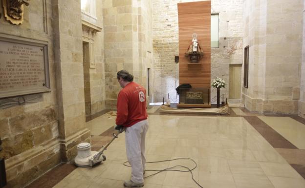 Un operario abrillanta la capilla de Covadonga, con uno de los huecos para tumbas a la izquierda. 