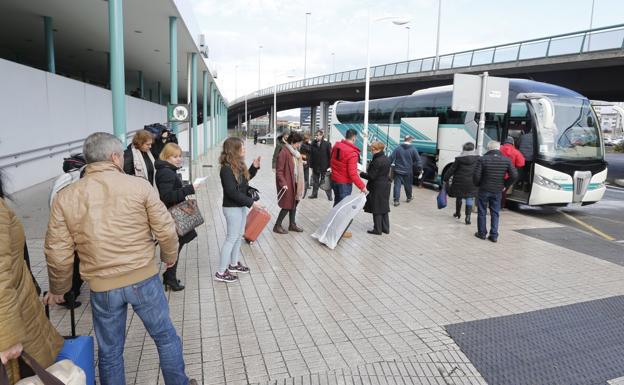 Pasajeros en Gijón a la espera de subir a uno de los autobuses que contrató Renfe. 