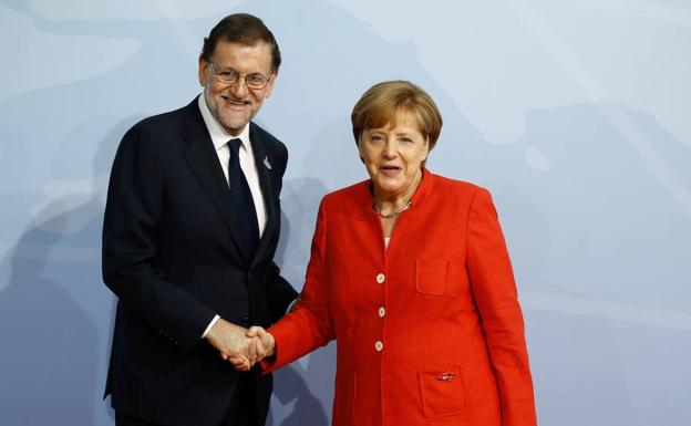 Rajoy y Merkel.