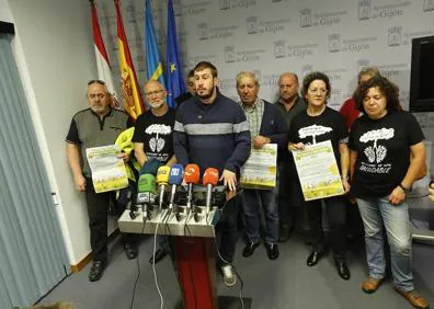 Imagen secundaria 1 - Arriba, un operario de limpieza retira una de las ratas muertas halladas en la playa, donde ondea la bandera roja (derecha). A la izquierda, comparecencia de la Plataforma Contra la Contaminación de Xixón.