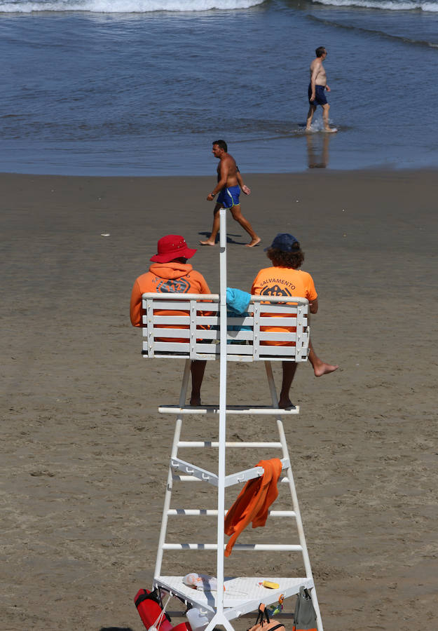 El sol y el calor anunciados para este fin desemana han llenado las playas de Asturias. En San Lorenzo, por ejemplo, miles de personas disfrutan del arenal y del paseo del Muro.