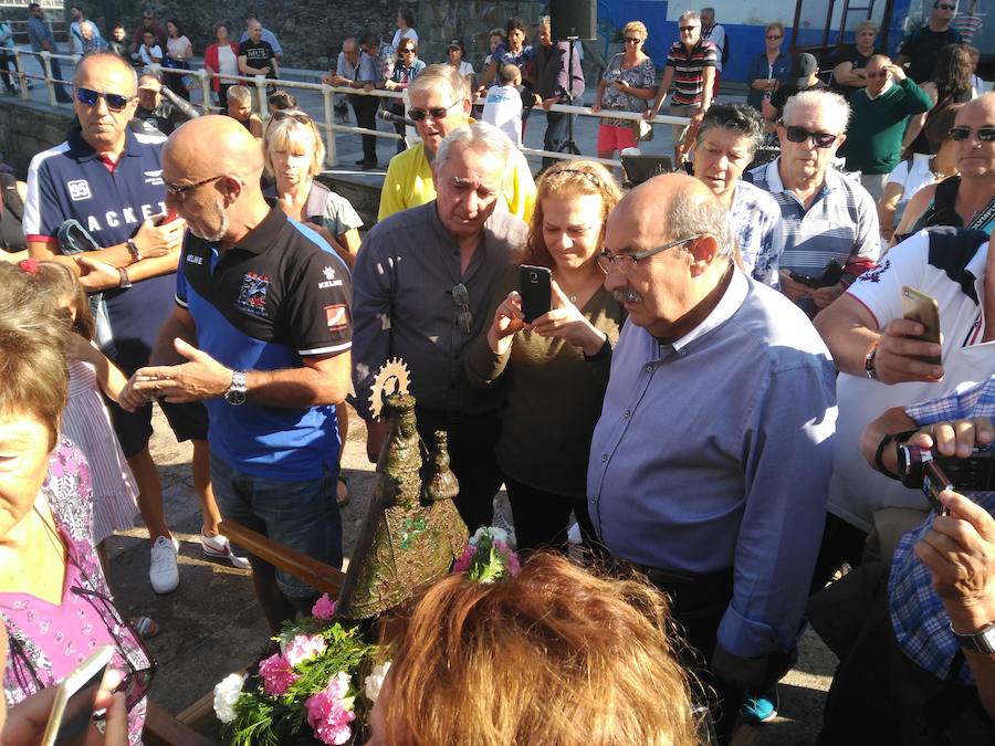 Decenas de personas se han congregado en el puerto de Cudillero para ver, un año más, a los submarinistas del Grupo Ensidesa de Actividades Subacuáticas (Club GEAS) sacar la imagen de la Santina del fondo del mar, una tradición que se remonta al año 1992. Tras llevar la talla en procesión hasta la iglesia, donde presidió la misa, fue devuelta al fondo marino, de donde resurgirá el próximo 8 de septiembre.