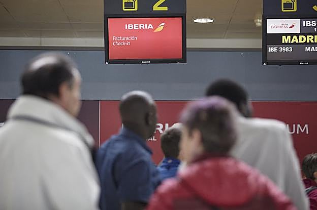 Viajeros en cola, esperando un vuelo para Madrid, en el aeropuerto de Asturias. 