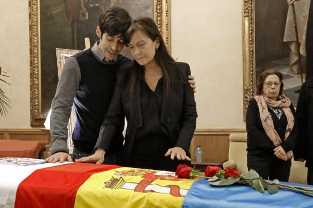 Soledad Saavedra y su hijo Alberto acarician el féretro de Areces, el viernes en el Ayuntamiento de Gijón.