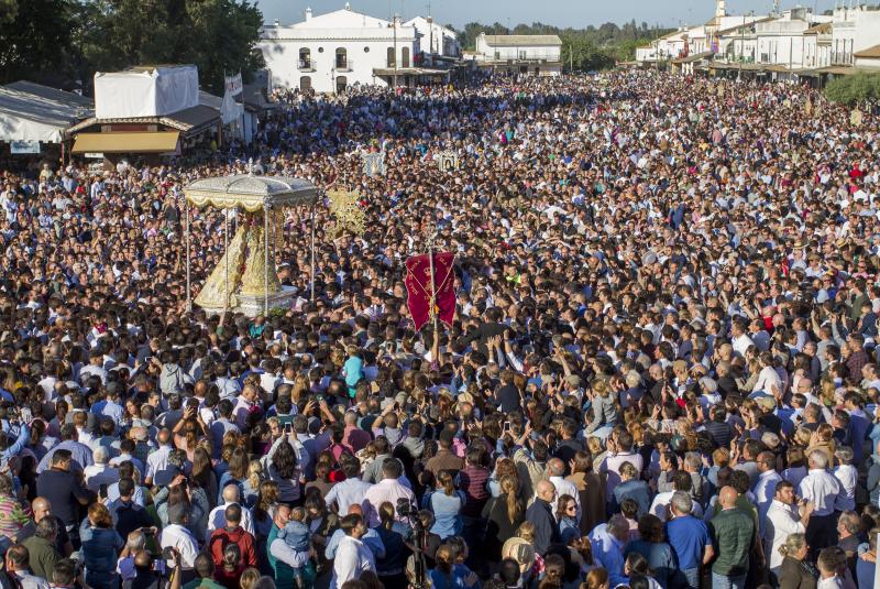 Multitudinaria y larga procesión de la Virgen del Rocío en Almonte (Huelva). En torno a las 2.49 horas de este Lunes de Pentecostés tuvo lugar el 'salto de la reja' y la imagen salió de la ermita para comenzar la tradicional procesión a hombros de los almonteños que se ha prolongado hasta las 12.31 horas, cuando ha vuelto a su Santuario. En su recorrido ante las 124 hermandades participantes, la Virgen ha vestido traje y manto con más de 2.000 piezas bordadas en oro fino en el taller de Fernando Calderón.