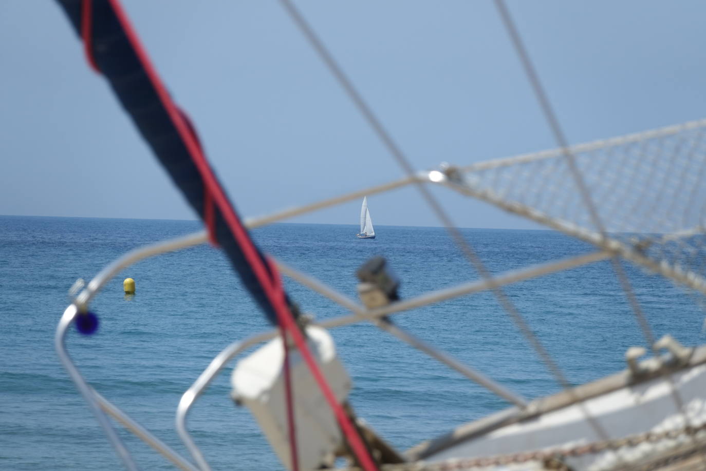 Una excavadora abre un canal en la playa de Santa Marina para intentar facilitar el posterior arrastre en pleamar del barco varado