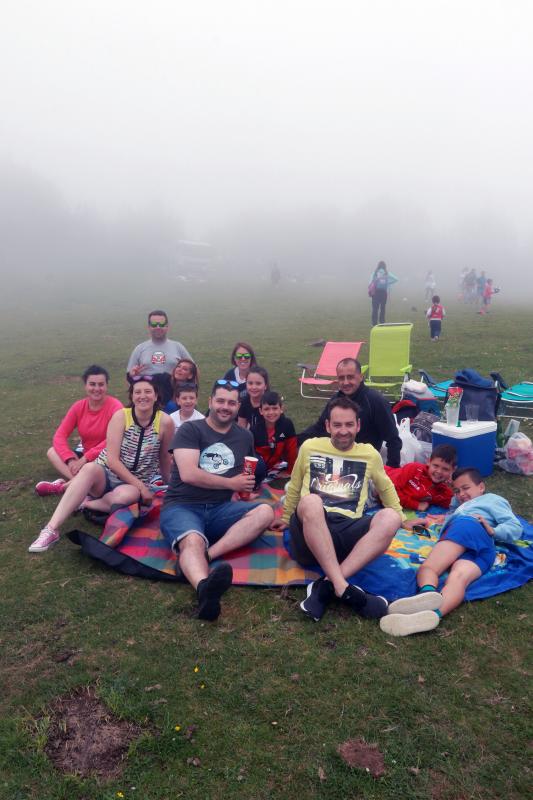 Centenares de personas han disfrutado en el prau Llagüezos del tradicional cordero a la estaca, plato principal de la fiesta de hermanamiento que se organiza entre los concejos de Quirós y Lena. A pesar de que la niebla ha cubierto buena parte de la celebración, el buen ambiente no se ha visto afectado.