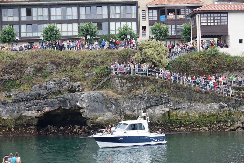 Miles de personas llenan la zona portuaria para ver la procesión. La imagen de la santa embarcó en en el 'Sandra María' y desde la cubierta del barco se lanzó al mar una corona de laurel