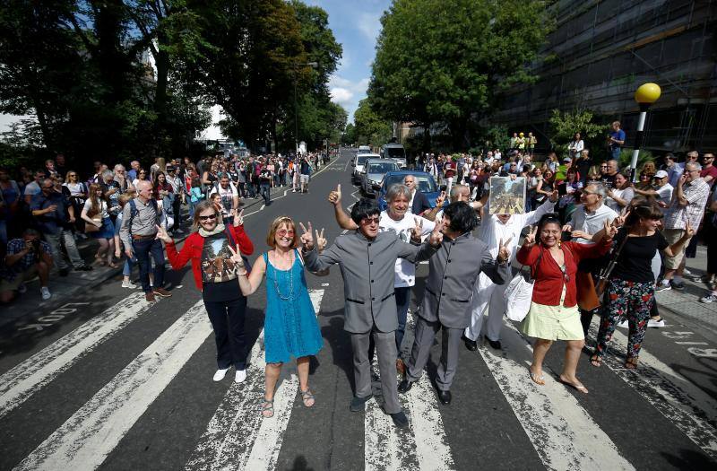 No hay duda. La foto de The Beatles cruzando por el paso de peatones de Abbey Road es una de las fotos más famosas de la historia de la música. Esa imagen cumple hoy 50 años y, para celebrarlo, centenares de fans se han congregado en la icónica calle. Incluso un grupo de imitadores del grupo británico llegó a la calle del barrio londinense de St John's Wood en una réplica del psicodélico Rolls Royce de John Lennon. Toda una gran fiesta para para conmemorar la iamgen que inmortalizó el escocés Iain Macmillan a las 11 horas y 35 minutos del 8 de agosto de 1969. En una sesión fotográfica de diez minutos hizo solo seis fotos y la que se convirtió en la imagen del álbum 'Abbey Road' fue la quinta, en la que los cuatro músicos caminan al unísono.