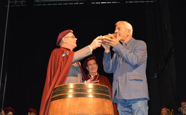 Carlos Sobera besa el cachu al recibir la distinción de la Cofradía del Vino de Cangas.