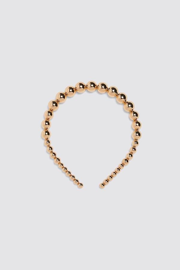Diadema de bolas doradas, 9,95 euros (Zara).