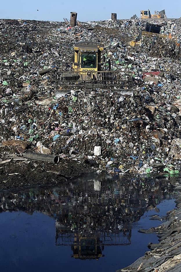 Máquina de Cogersa colocando la basura del vertedero. 