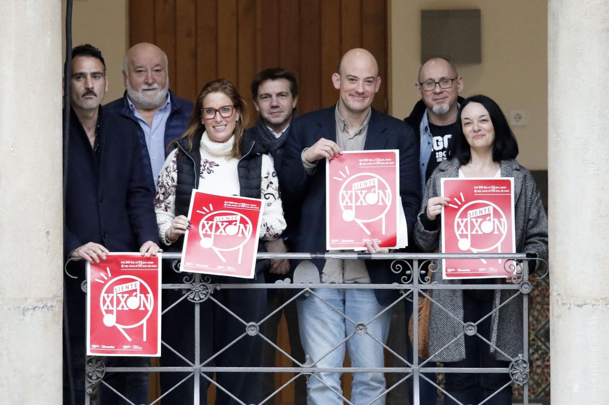Los participantes, con el cartel anunciador. 