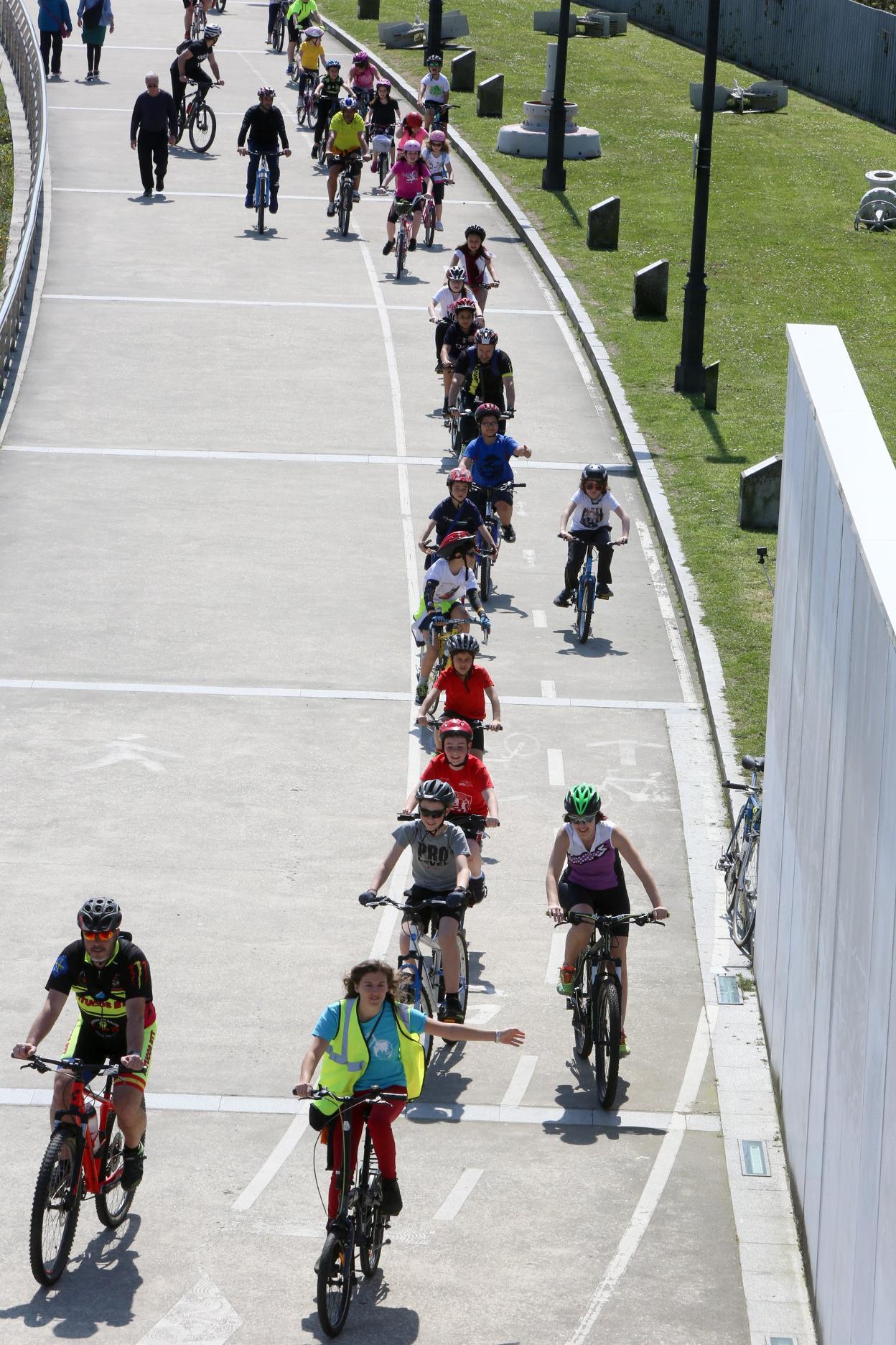 Ciclistas en el único carril bici de la ciudad, en el paseo de la ría. 
