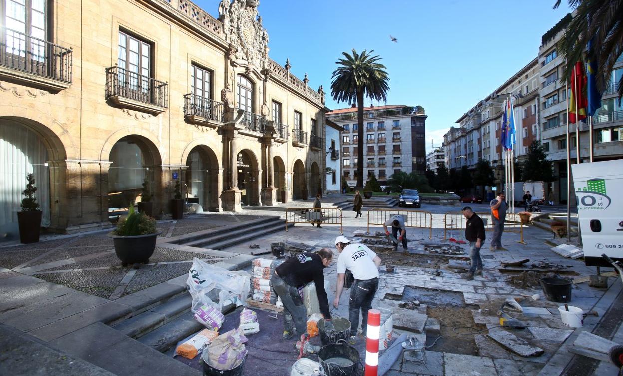 Los operarios, ayer, durante las obras de recambio de las losetas de acceso al hotel. 