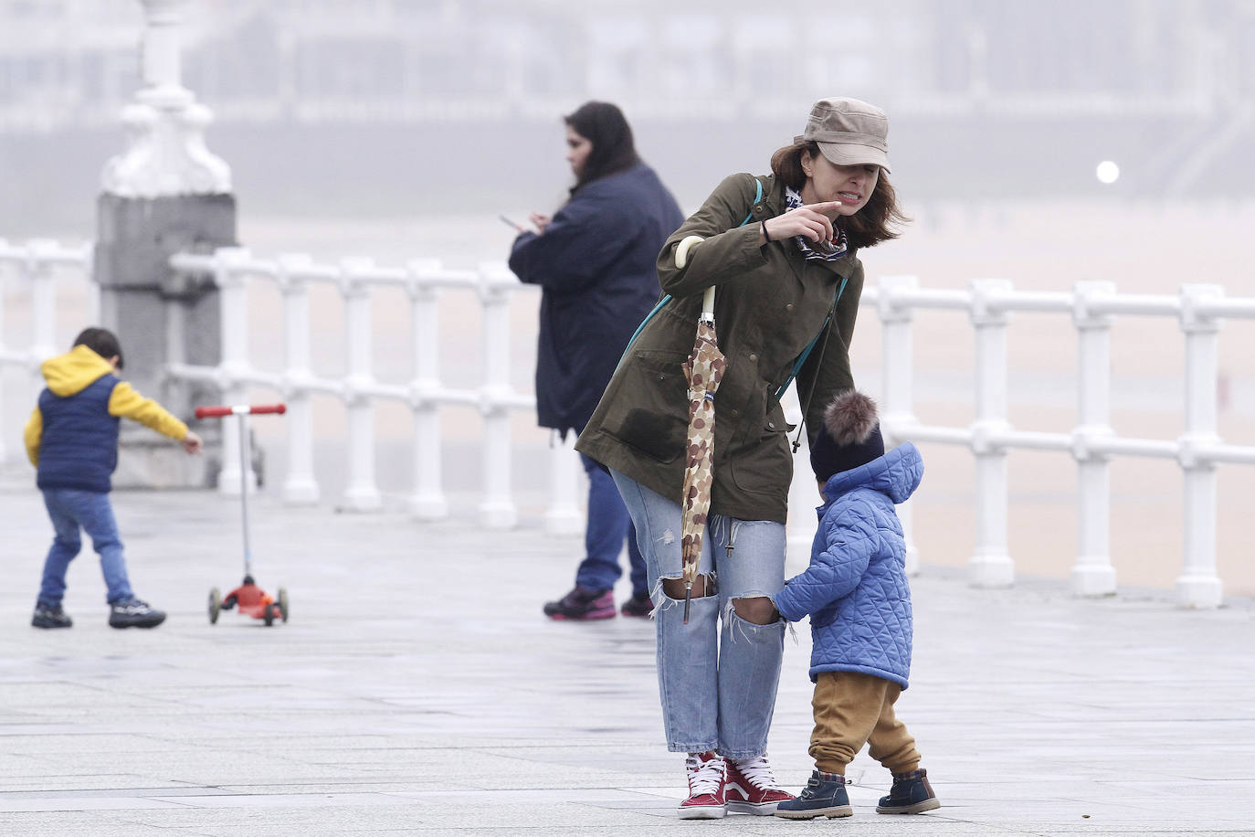 Primeros paseos bajo el orbayu en Gijón de los más pequeños