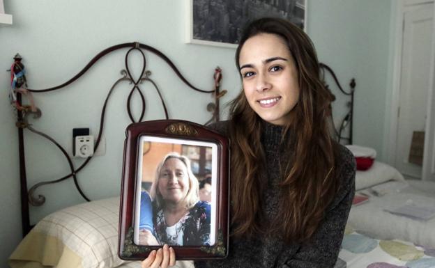 La enfermera Elena Andión, con la foto de su madre, María José Torralba. juan carlos tuero