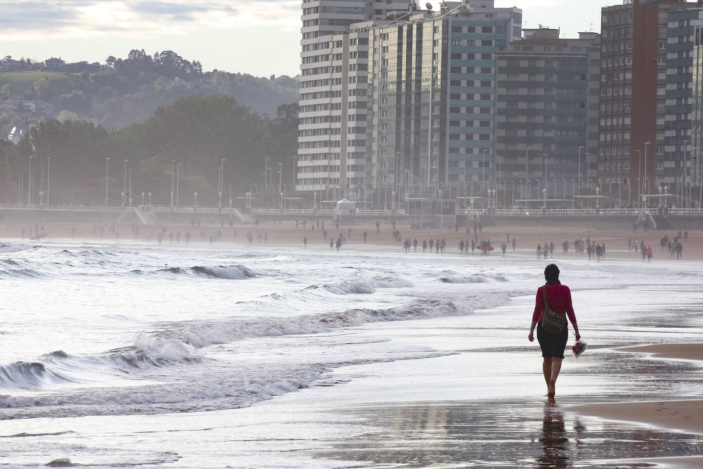 02 de mayo. Gijón | Adultos practicando deporte y paseando por la playa de San Lorenzo en la franja horaria estalecida para este segmento de la población durante la fase 0 de la desescalada del confinamiento por el coronavirus. 
