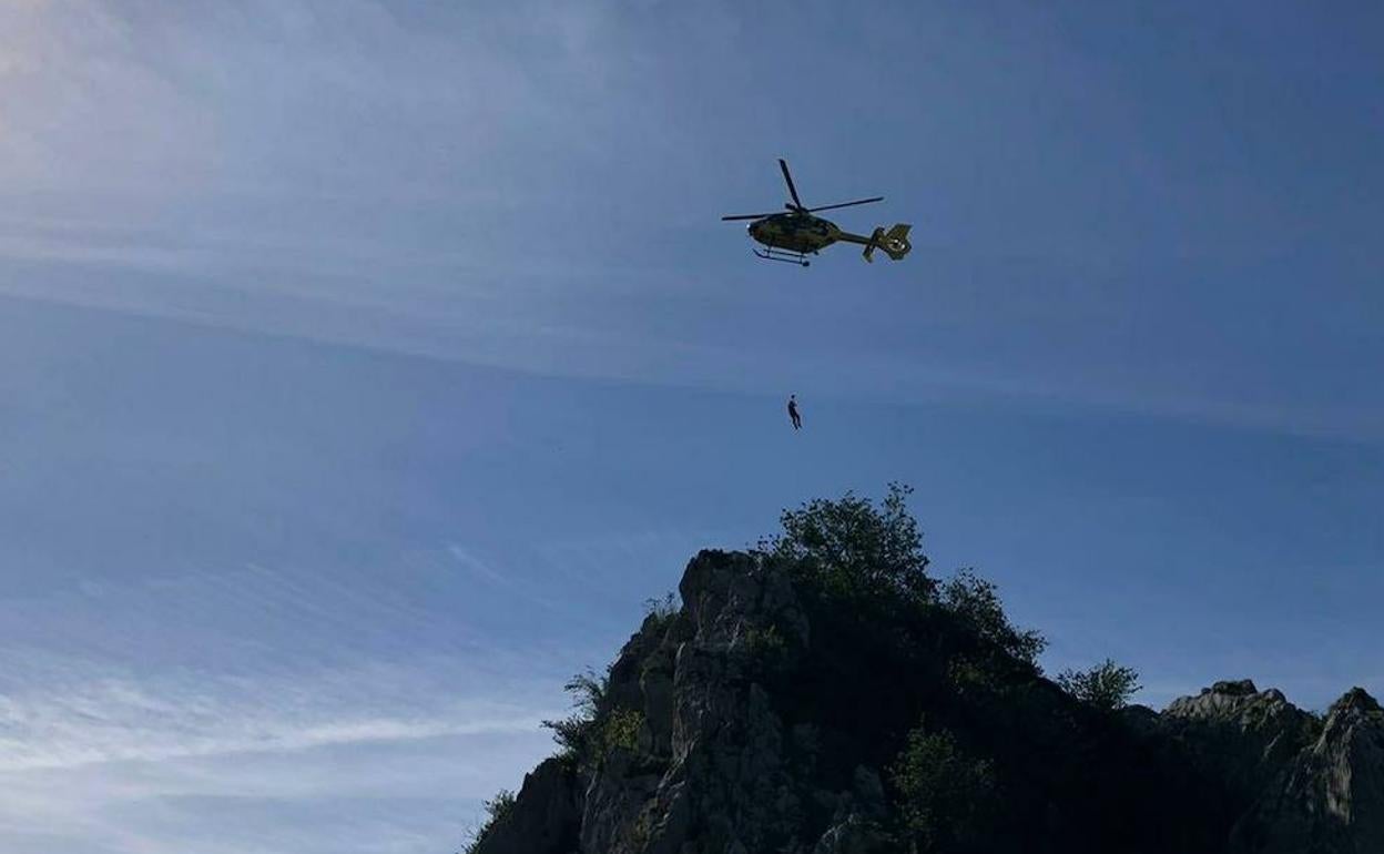 El helicóptero de Bomberos, durante el rescate de una de las personas.