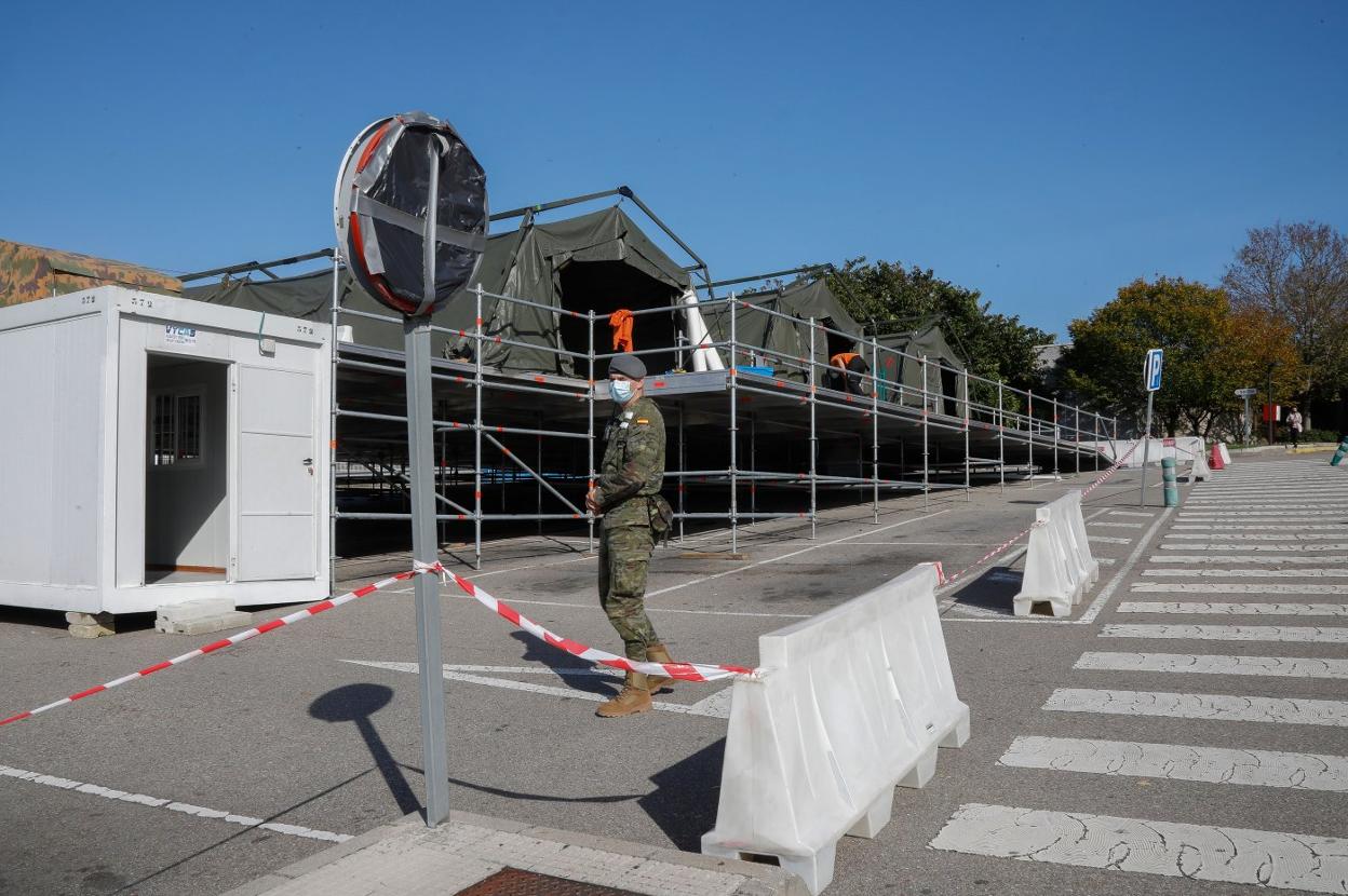 Un soldado custodia la unidad de triaje del Ejército instalada en Cabueñes y que sigue sin funcionar a la espera de personal. 