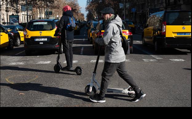 Taxis y patinetes en una calle de Barcelona, en 2019 