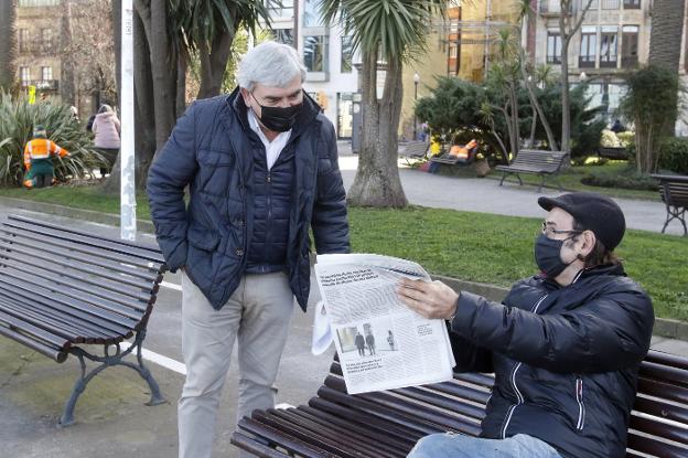 Un hombre muestra un ejemplar de EL COMERCIO a Mariano Marín en los Jardines de la Reina. 