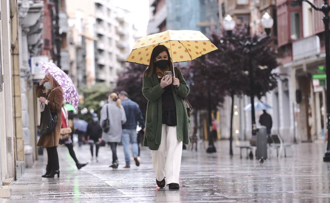 Viandantes con paraguas, este lunes en Gijón 