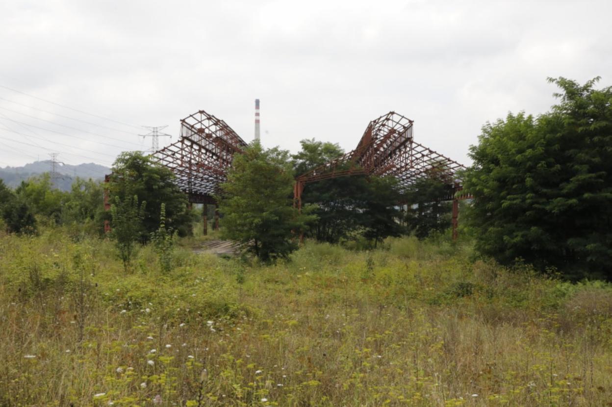 Parcela de los antiguos Talleres del Conde con la estructura de metal que se rehabilitará para el recinto ferial de Langreo. 
