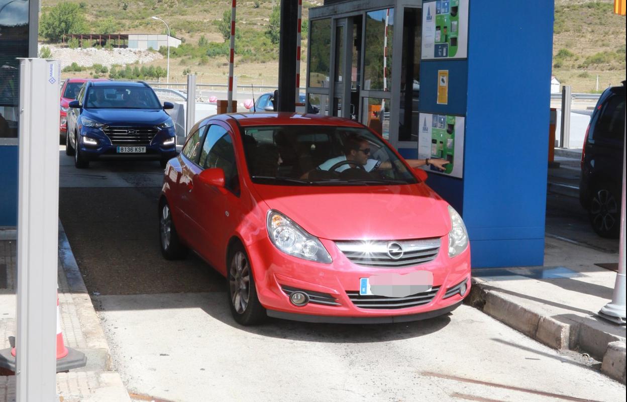 Un conductor procede al pago del peaje en el punto de control de La Magdalena, en la autopista del Huerna. 