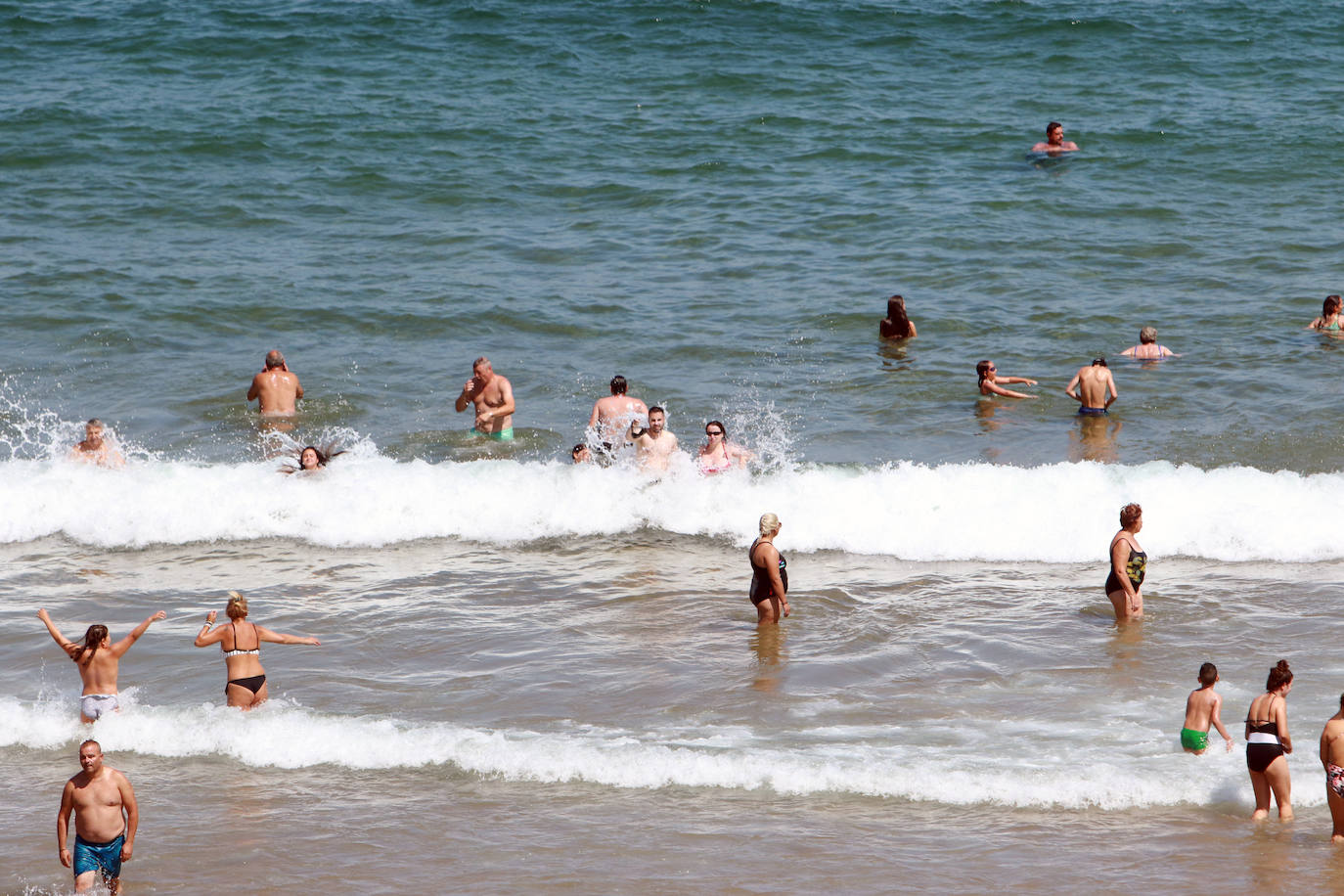 El verano se ha hecho notar este viernes en Asturias. El calor ha empujado a turistas y locales a las playas. De hecho, el arenal de San Lorenzo tuvo que cerrar durante cuatro horas porque se llenó el aforo. 