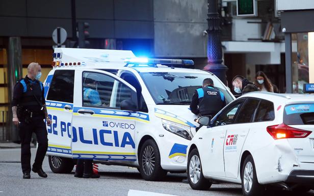 Imagen principal - Herido un motorista tras embestir a un taxi en la plaza de Primo de Rivera de Oviedo