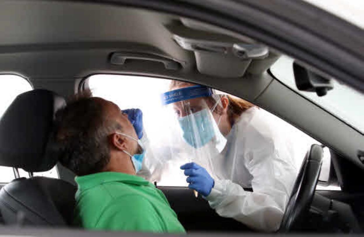Una enfermera realiza una prueba PCR en el autocovid del HUCA. 