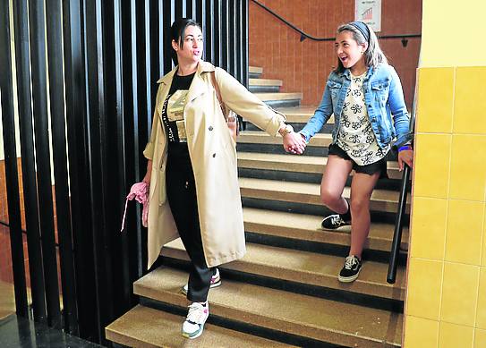  La niña con su madre, Dolores Molina, baja las escaleras delcolegio.