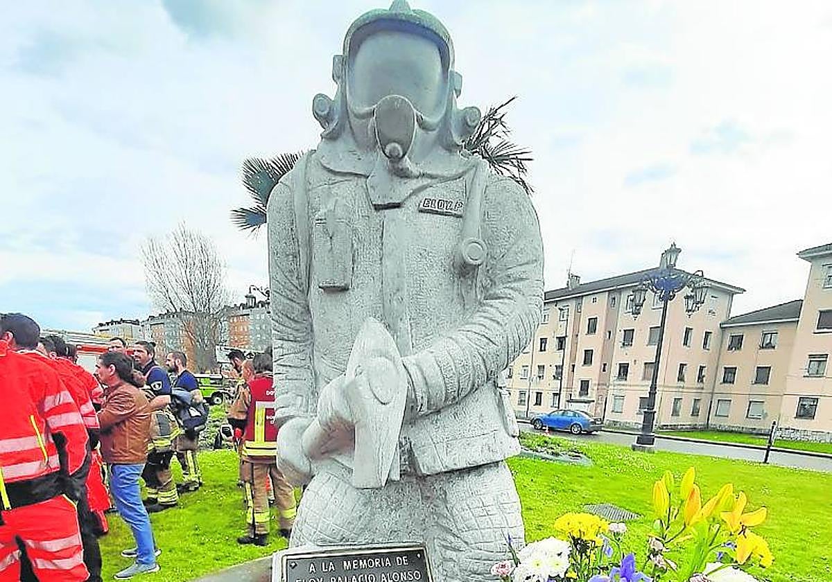 Las flores ante la estatua de Eloy Palacio.