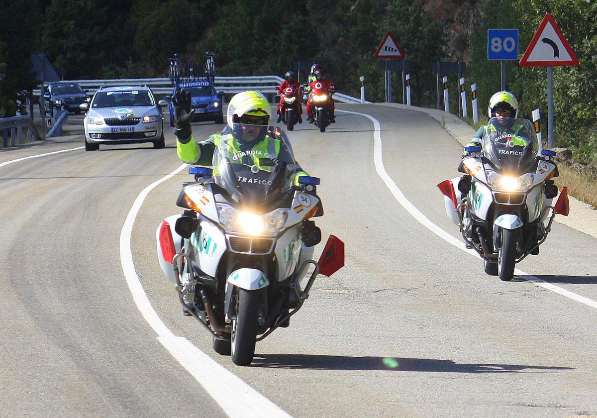 Agentes de la Guardia Civil llevan banderas rojas en sus motos.