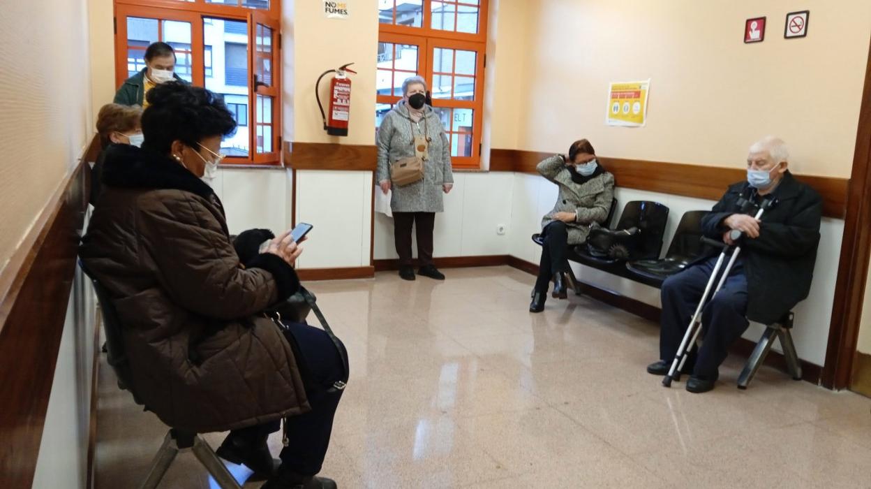 Usuarios del centro de salud de Villaviciosa aguardan en la sala de espera a ser llamados para su consulta con el médico. 