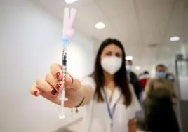 Una enfermera del equipo de vacunación del HUCA muestra una de las dosis administradas contra la gripe.
