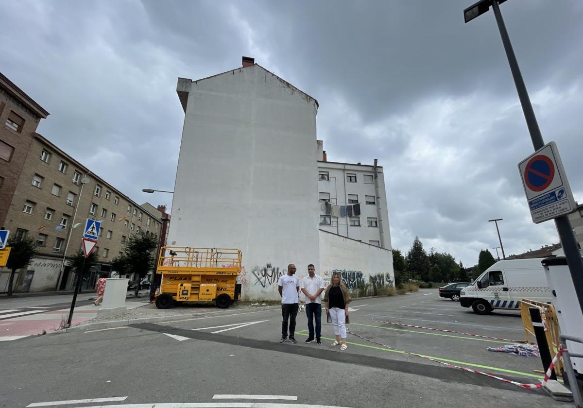 Los ediles Javier Rodríguez y Sonia Lago, con el artista 'Sojo', delante de la pared en la que se pintará el mural.