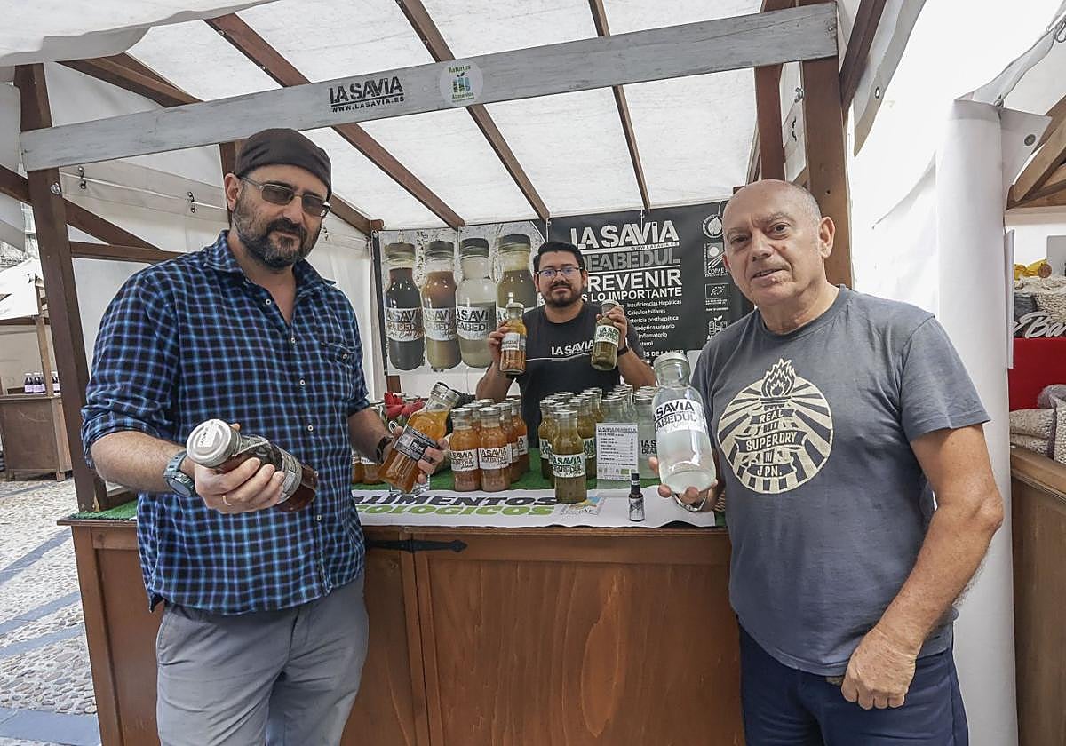 Ignacio Valdés, Christian Acurio y Miguel Couto, con las cinco variedades de su producto en el mercado ecológico de Gijón.