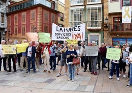 Los vecinos de Latores, con pancartas, durante la concentración este mediodía.