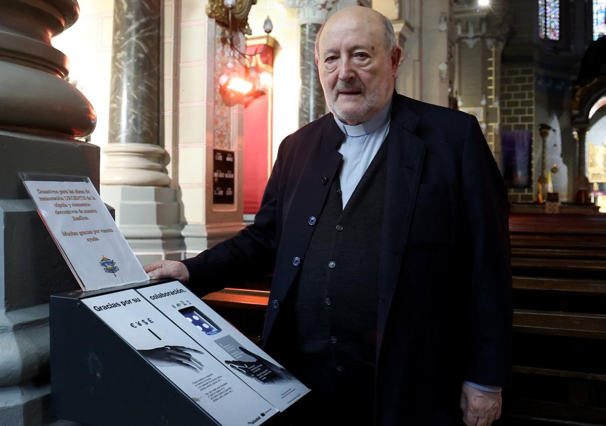 El párroco de San Juan El Real de Oviedo, Francisco Javier Suárez. junto al cepillo electrónico.