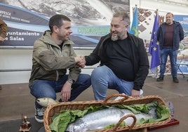 Javier Bueno, el pescador sacó el Campanu, estrecha la mano a Pedro Caramés, que ganó la subasta y se llevará el ejemplar al restaurante La Finca de Oviedo.