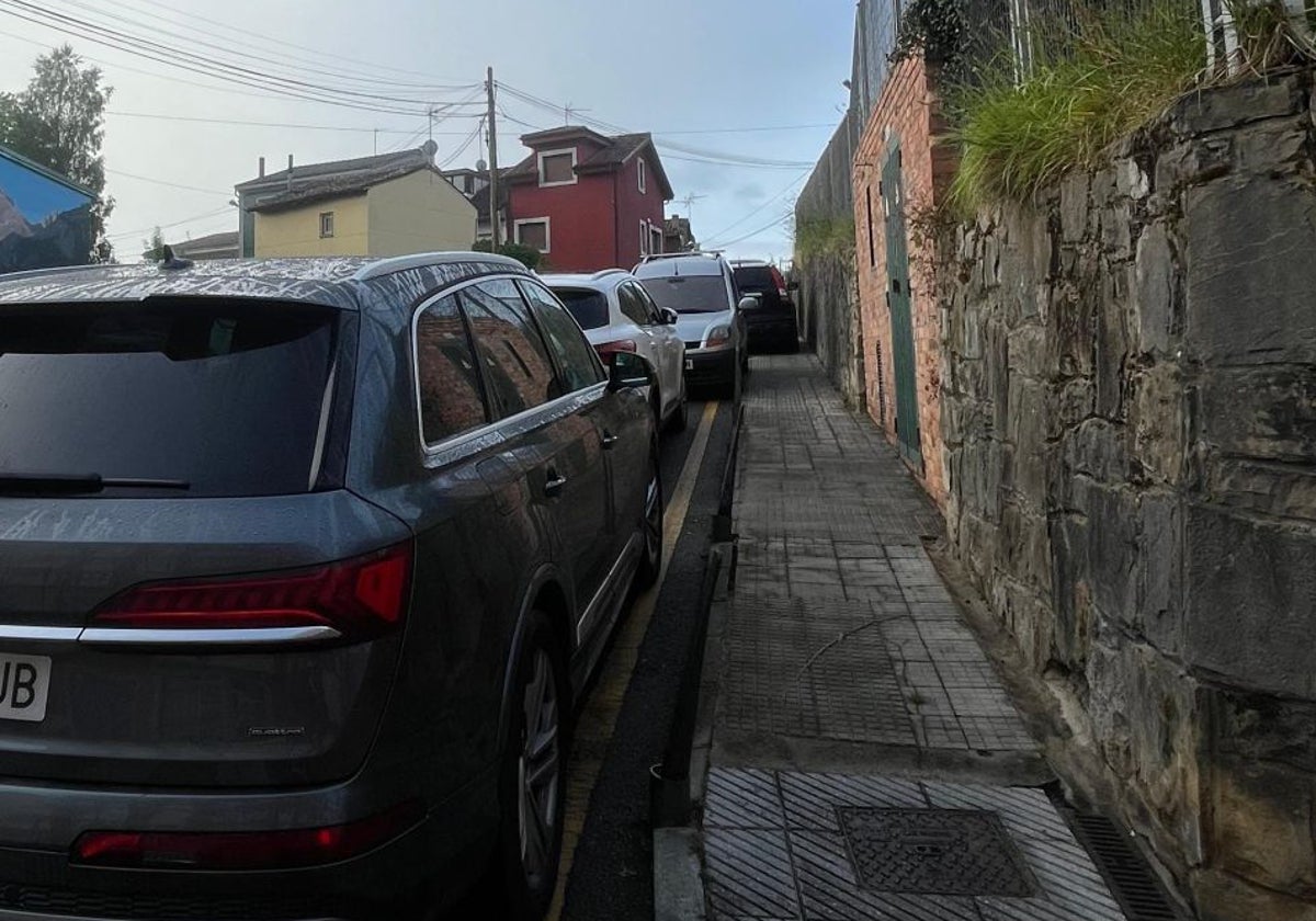 Coches mal aparcados, incluso sobre la acera, en el vial junto al instituto Río Nora, en una foto facilitada por los vecinos.