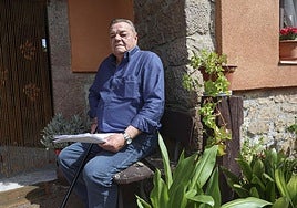 José Ramón Fernández, sentado a las puertas de su casa con la documentación que ha ido recopilando estos años de visitas al hospital.