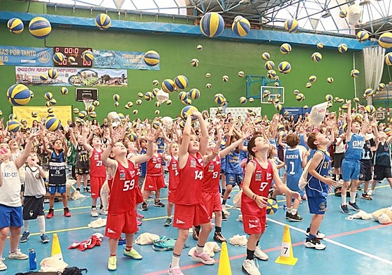 Los pequeños participantes lanzan el balón al techo del polideportivo en una jornada de competición pero sobre todo festiva.
