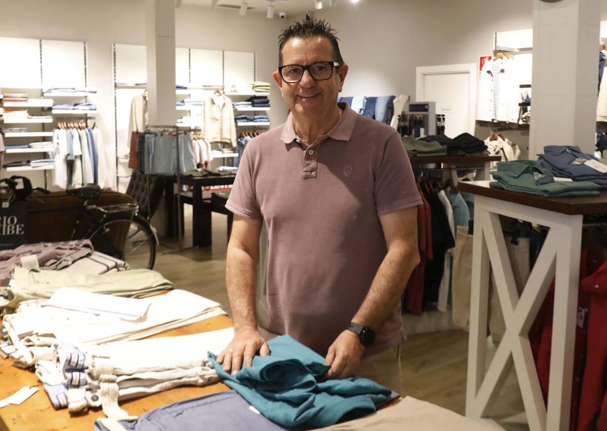 Imagen secundaria 1 - Arriba, Andrés Crespo, de Cresport, atiende a unos clientes. A la izquierda, Manuel Palizas, encargado de Del Río Uribe Avilés, dobla una camisa de caballero y a la derecha, Anisoara Lenuta Tarcaet, de T&T, coloca una percha.
